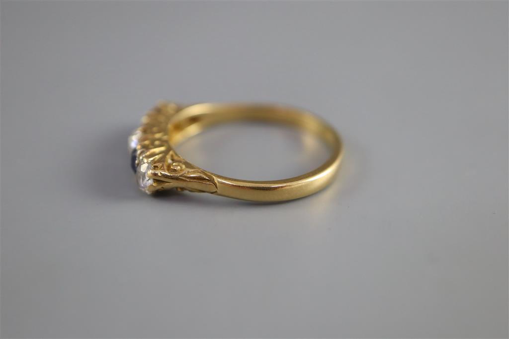 An early/mid 20th century 18ct gold and platinum, two stone sapphire and three stone diamond half hoop ring,
